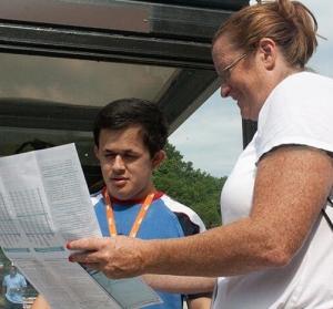 A female travel trainer shows a young man a transit system map. Working with PRTC, MTM created a sustainable travel training program that focuses on train the trainer training opportunities.