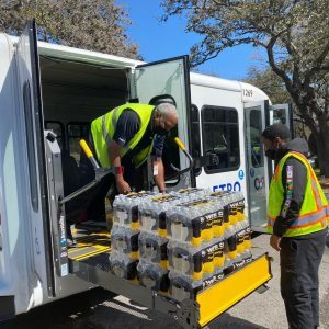 Drivers loading donated water bottles for Capital Metro. In partnership with Austin Capital Metro, MTM Transit stepped up to deliver bottled water in the aftermath of the 2021 Austin winter storm.