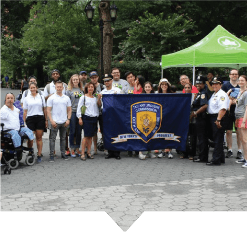 The Accessible Dispatch and TLC outreach teams pose for a photo at the NYC Pride parade, where the teams spread the word about accessible taxi service in New York City.
