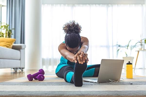 A woman practices yoga. Health and wellness are important benefits of MTM Transit careers and MTM Transit jobs, including our driver jobs.