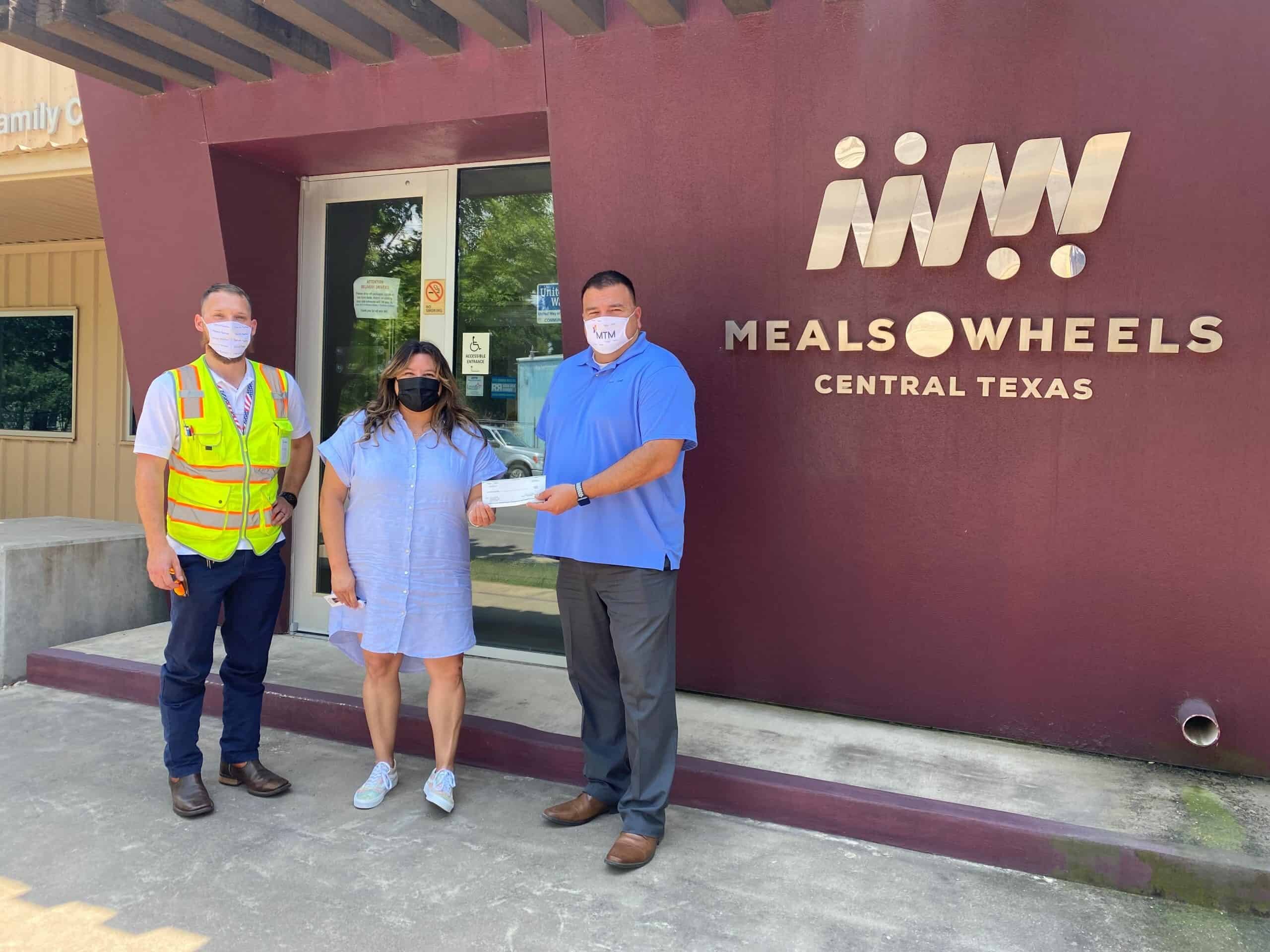 MTM Transit staff present a $500 donation to Meals on Wheels of Central Texas.