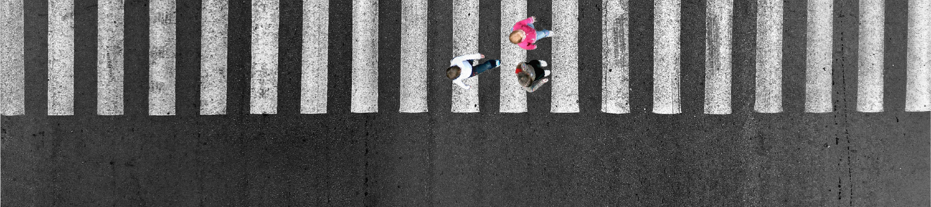 Kids crossing a road via the crosswalk