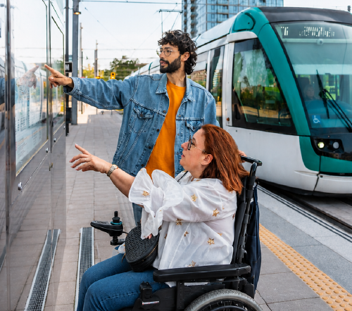Travel trainer and trainee looking at a transit map