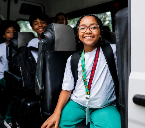 Smiling students in the back of a van
