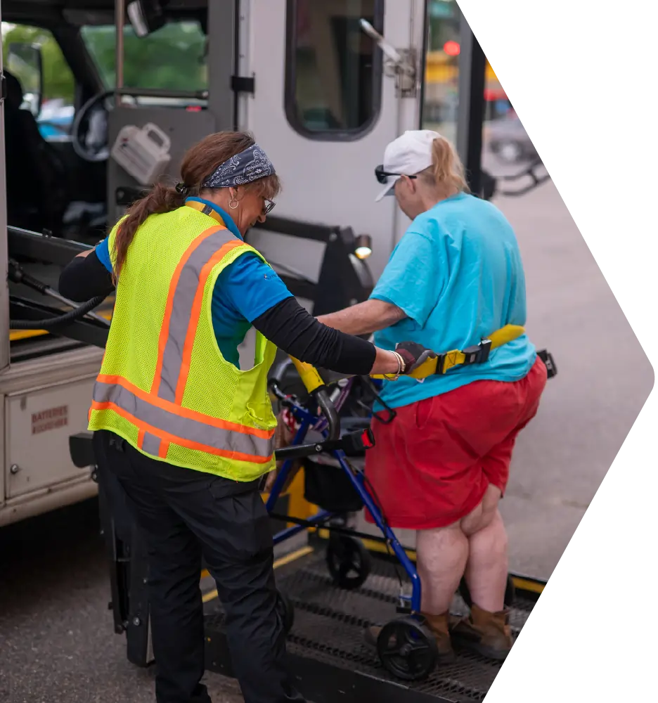 Driver raising passenger up on the bus lift