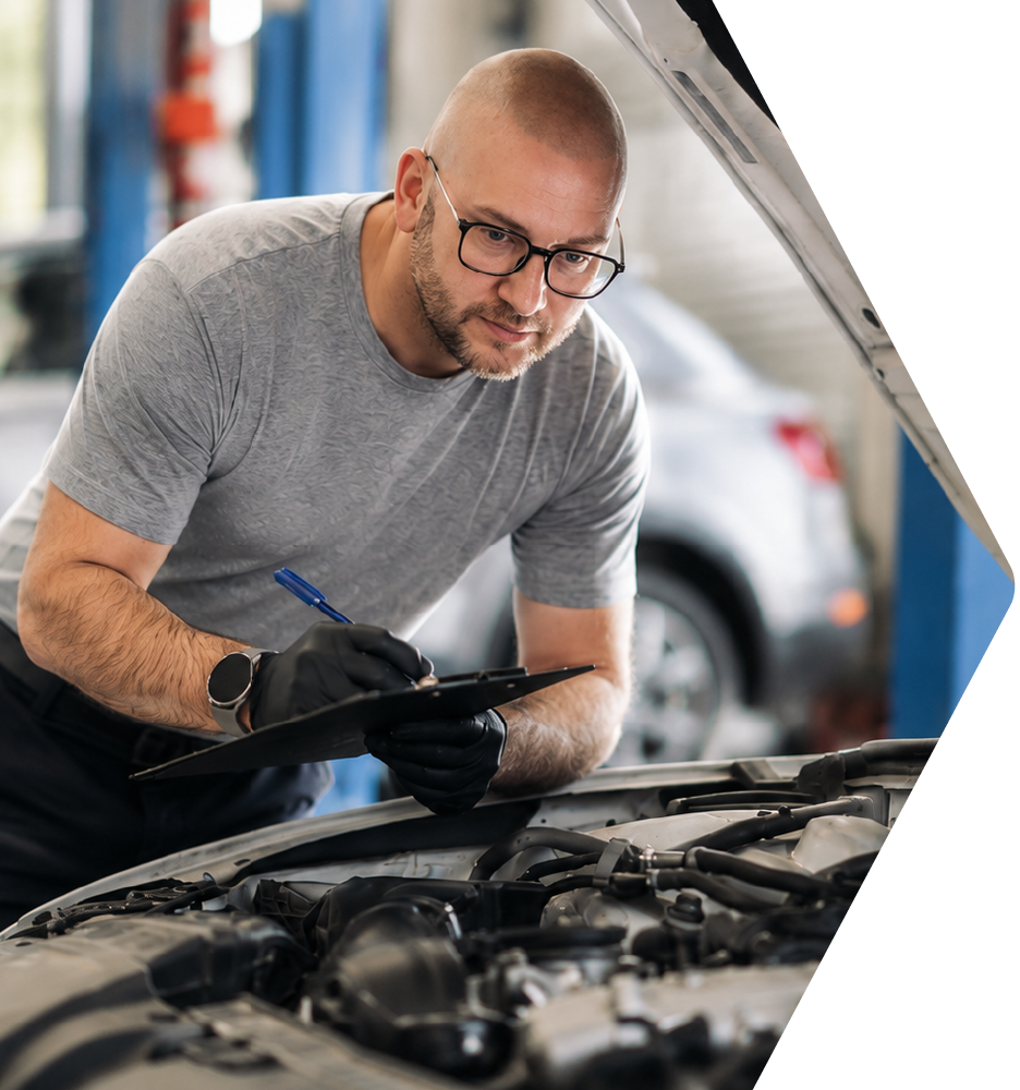 Driver looking under the hood of a vehicle
