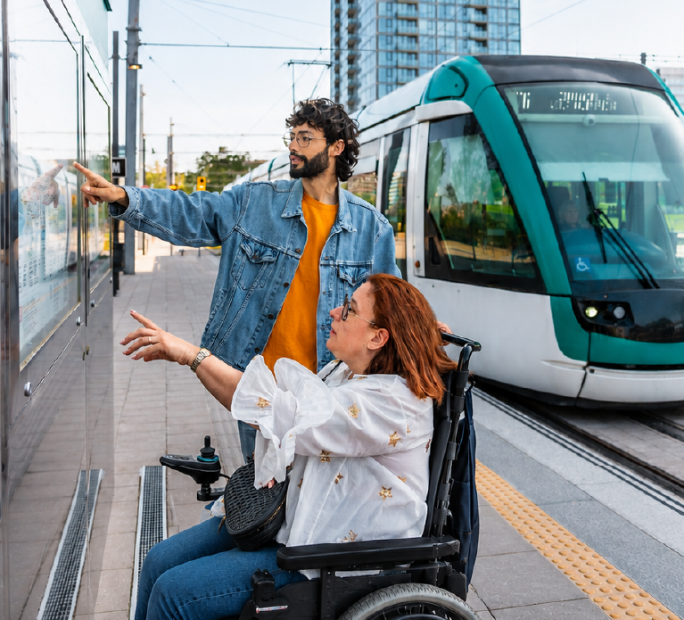 Travel trainer and trainee looking at a transit map